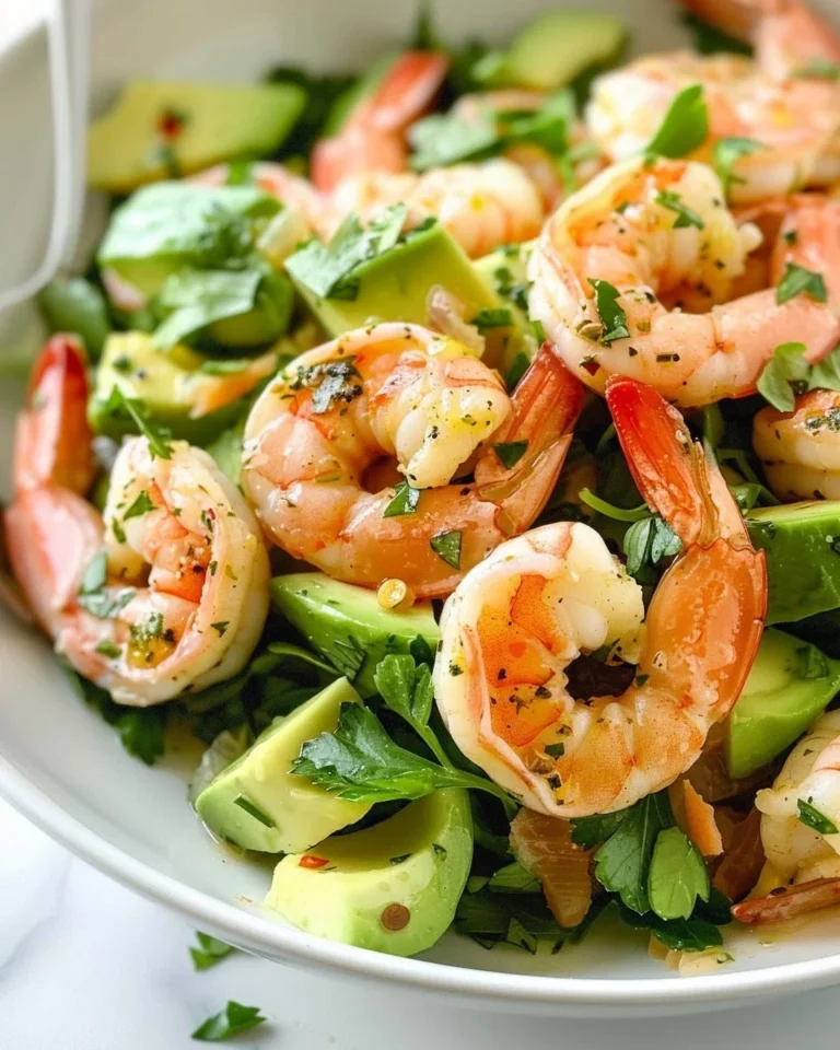 Citrus shrimp salad with avocado on a plate, showcasing vibrant colors and fresh ingredients.