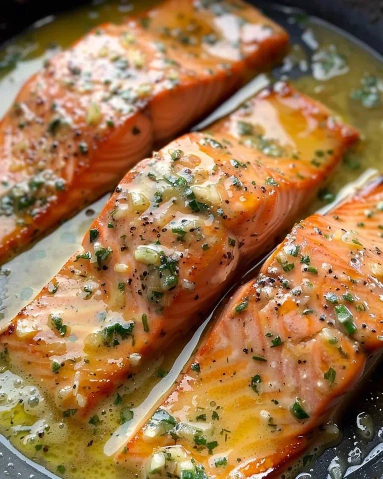 Delicious garlic butter salmon fillet garnished with herbs on a plate